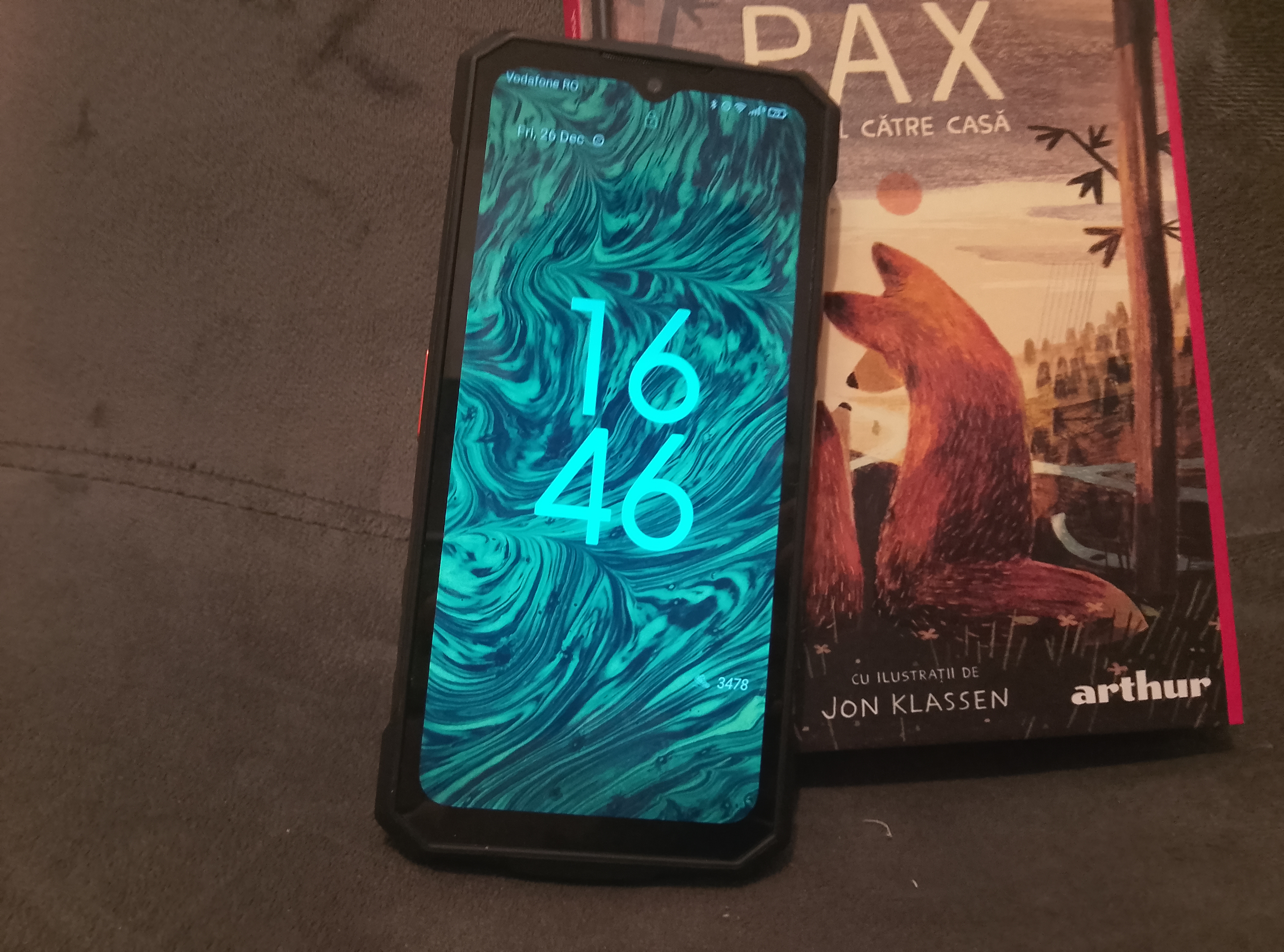 The Fire 7 Pro next to a book. (Image source: Sergey Tarasov - Notebookcheck)