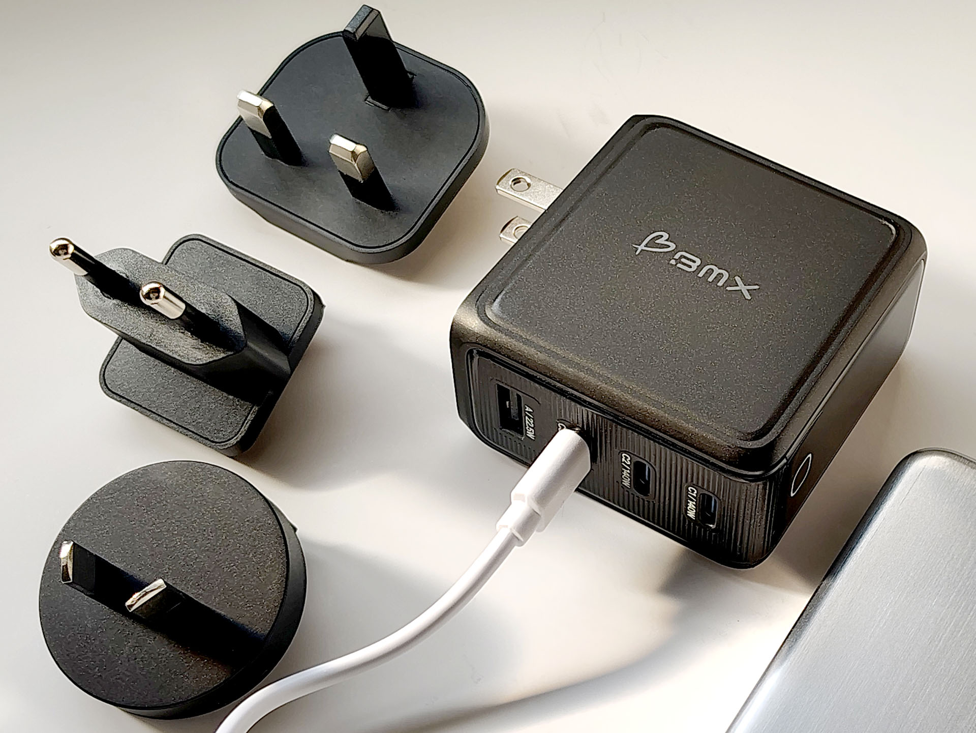 BMX GaNSTA 140W USB charger with worldwide AC adapters.