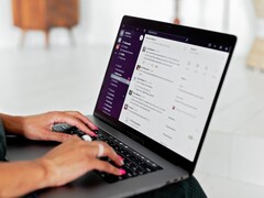 Hands typing on a laptop with a chat application open