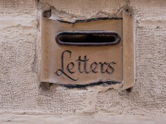 Stone letter slot with the word Letters carved into a wall