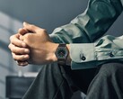 Citizen Eco-Drive One AR5065-54W on a wrist, featuring a forest green and black dial, rose gold accents, and an ultra-thin black-coated bracelet.