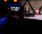 A photograph of a camera filming an interview