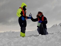 Researchers Mariam Naseem and Marc Neveu sampling and bottling brine from sea ice in Antarctica