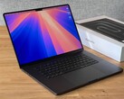 The photo shows the MacBook Pro 16-inch M5 Pro in the space black colorway sitting next to its box