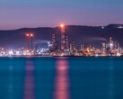 Illuminated oil refinery at night with bright lights. (Image source: Selim Şengül via Pexels)