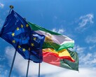Flags of the European Union fly against a blue sky
