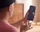 Person signing one-handed in front of a Pixel phone that shows the recognised text in Gboard