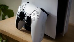 A screengrab of a PlayStation 5 DualSense controller leaning against a PS5 console