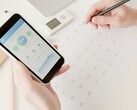 A hand holding a smartphone with the health app open