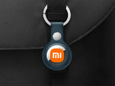 There will UWB and non-UWB versions available. Pictured: edited picture showing Apple Tag with Xiaomi logo hanging on a bag. (Image source: Apple and Xiaomi)