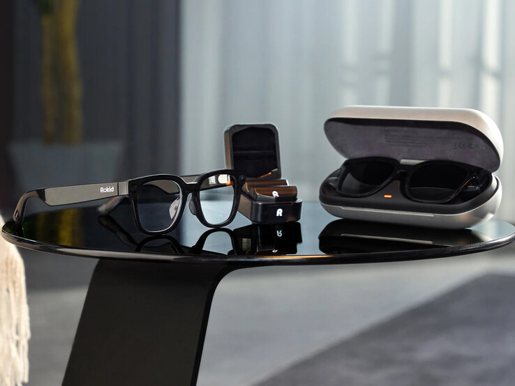 The charging case (right) next to the Power Capsule (middle) and the glasses (left)