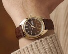Timex Q 1978 Day and Date with a brown fumé dial and gold-tone case, shown on a wrist with a brown leather strap.