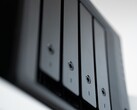 Close-up shot of a black NAS enclosure with multiple drive bays