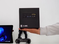 3D-printed ITG Cube gaming PC shown in hand, featuring a compact Steam Machine-style enclosure with front I/O ports and minimalist design.