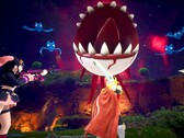Palworld screenshot showing characters fighting a floating eyeball with sharp teeth