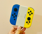 Stock image. A hand holding Joy-Cons (Image source: Gwen King on Unsplash)