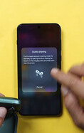 A OnePlus phone displaying the audio-sharing setup screen, prompting the user to place a second pair of wireless earbuds into pairing mode.