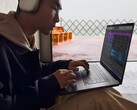 A man in front of a laptop (Image Source: Apple)