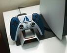 A custom God of War-themed DualSense controller resting on a charging dock in front of a PlayStation 5 console. (Image source: FOX ^.ᆽ.^= ∫)