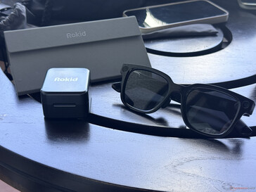 The Rokid Power Capsule next to the carrying case and the glasses