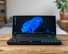 Keebmon folding keyboard PC shown running Windows 11, featuring a 13-inch ultrawide touchscreen and RGB mechanical keyboard design