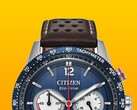 Close-up of the Citizen Racing Chronograph CA4716-09L, showing its blue tachymeter bezel, deep blue dial with silver-tone hands and markers, three subdials, red central seconds hand, and brown perforated leather strap against a yellow background.