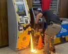 A police officer cutting into the Bitcoin ATM with a hand-held abrasive saw (Image source: Jasper County Sheriff’s Office via Facebook; cropped)