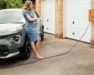 A lady waiting for an EV to charge up