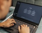 A person is typing on a laptop with the ChatGPT interface open
