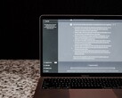A laptop with an AI chat window open on a dark background; stock image depicting on-premises AI without the cloud.