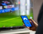 A hand is holding a smartphone with the VPN app open