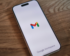 An iPhone with the Gmail logo on the screen.
